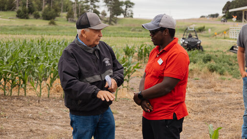Extension specialist talking to a farmer