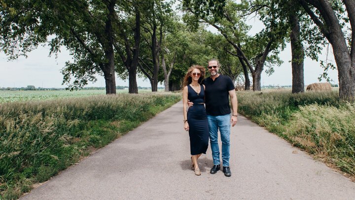 Couple stands on Tree Lane Road following their donation